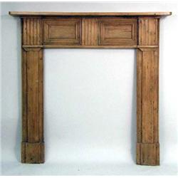 A PROVINCIAL MOLDED AND PANELED PINE MANTLE
