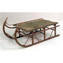 A RED PAINTED OAK AND METAL SLEIGH