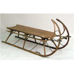A RED PAINTED OAK, PINE, AND METAL SLEIGH