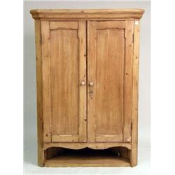 A PANELED PINE HANGING CORNER CUPBOARD