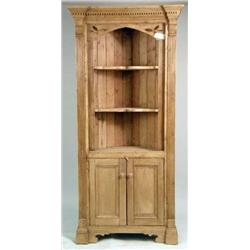 A CARVED PINE CORNER CUPBOARD