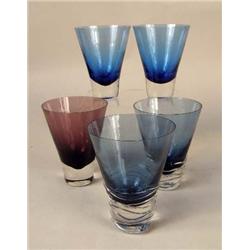 A GROUP OF COLORED GLASS BARWARE