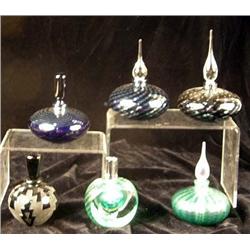 A GROUP OF SIX FROSTED AND COLORED GLASS PERFUME BOTTLES