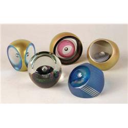 A GROUP OF FIVE IRIDESCENT GLASS PAPERWEIGHTS