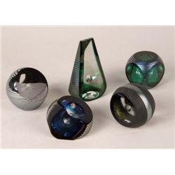A GROUP OF FIVE IRIDESCENT AND STRIPED GLASS PAPERWEIGHTS