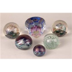 A GROUP OF FIVE GLASS PAPERWEIGHTS