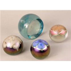 A GROUP OF FOUR GLASS PAPERWEIGHTS