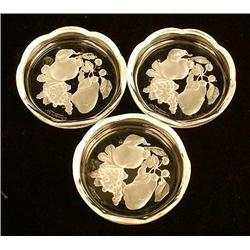 A GROUP OF COLORLESS GLASS COASTERS