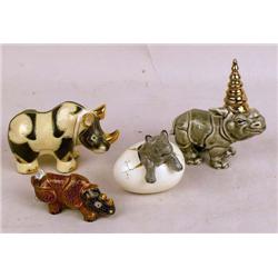 A GROUP OF ASSORTED POLYCHROME-DECORATED PARCEL-GILT PORCELAIN RHINOCEROS FIGURINES