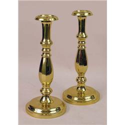 A PAIR OF CAST-BRASS CANDLESTICKS