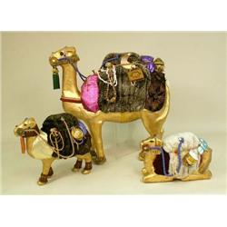 A GROUP OF THREE PAPER MACHE GILT AND JEWEL DECORATED CAMELS