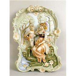 A POLYCHROME DECORATED PORCELAIN PLAQUE
