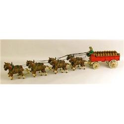 A CAST IRON POLYCHROME PAINT DECORATED BEER WAGON TOY