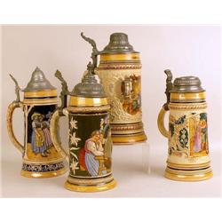 A GROUP OF FOUR GLAZED CERAMIC BEER STEINS