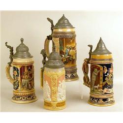A GROUP OF FOUR GLAZED CERAMIC BEER STEIN