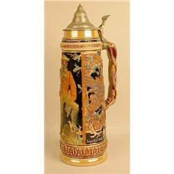 A GLAZED CERAMIC BEER STEIN IN RELIEF