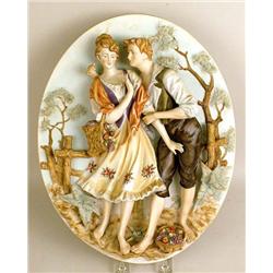 AN OVAL POLYCHROME-DECORATED PORCELAIN PLAQUE
