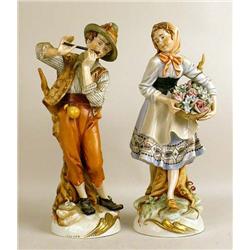 A PAIR OF POLYCHROME-DECORATED PORCELAIN FIGURES