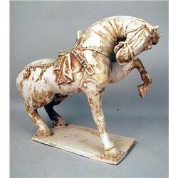 A RED AND BLACK PAINTED PRANCING POTTERY HORSE