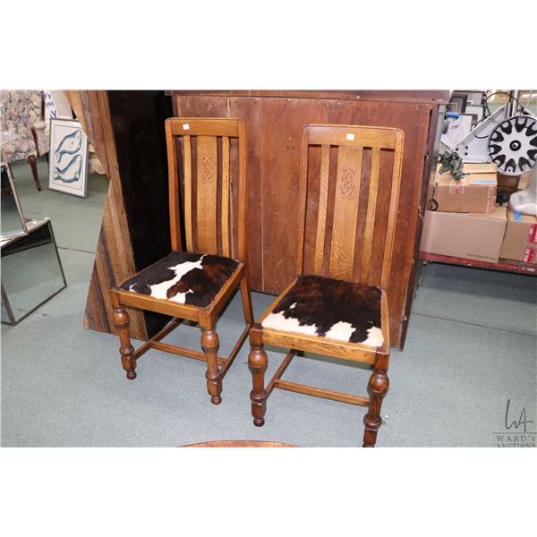 Pair of quarter cut oak slat back chairs with turned bulbous supports and hide upholstery