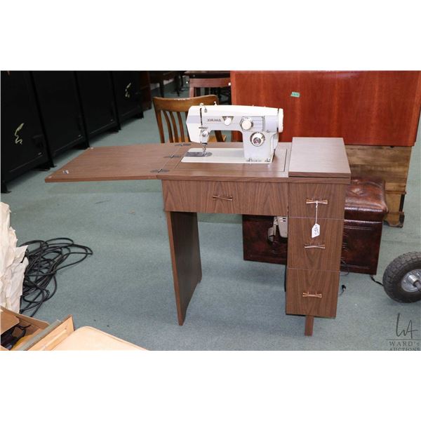 Vintage Viking sewing machine in cabinet with accessories