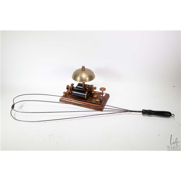 Antique Morse code telegraph with bell enunciator and an antique carpet beater