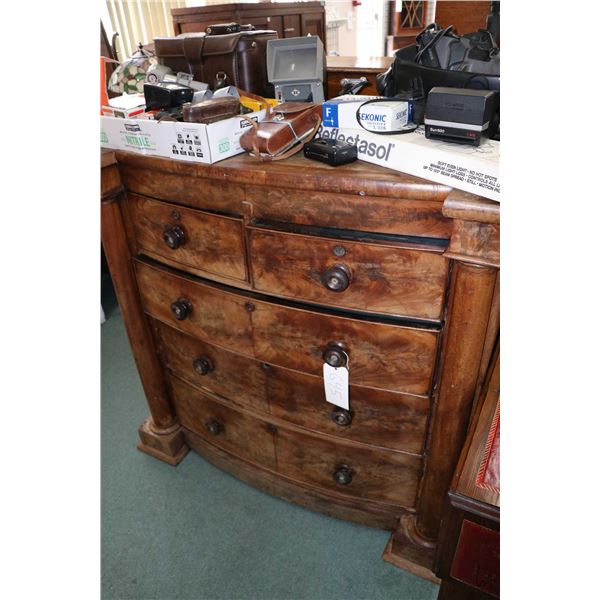 Antique five drawer matched grain bedroom chest with simulated column decoration and turned wooden k