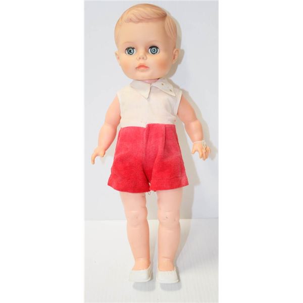 UNMARKED OPENING/CLOSING EYES BOY DOLL IN RED SHORTS.  #5101