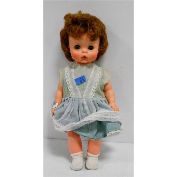 GIRL CHILD PLASTIC DOLL IN GREEN DRESS
