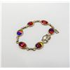 Image 1 : DESIGNER GOLD TONE BRACELET WITH IRIDESCENT