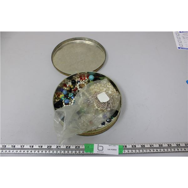 Jewelry and beads in metal tin