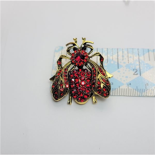 6)  GOLD TONE AND RED RHINESTONE FLY BROOCH