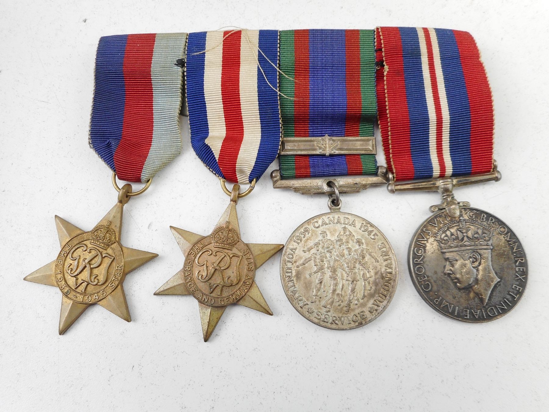 WWII CANADIAN MEDALS WITH RIBBONS AND RIBBON BAR.