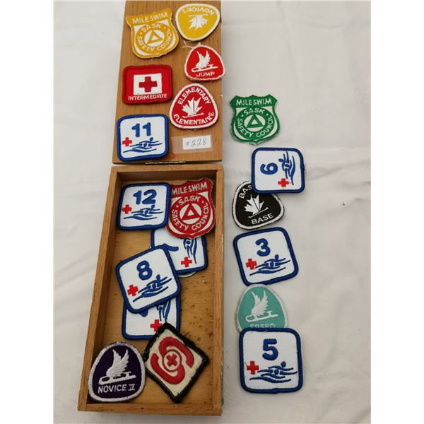 Cigar box with skating and swim badges