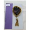 Image 1 : Articulated gold tone broach with purple glass