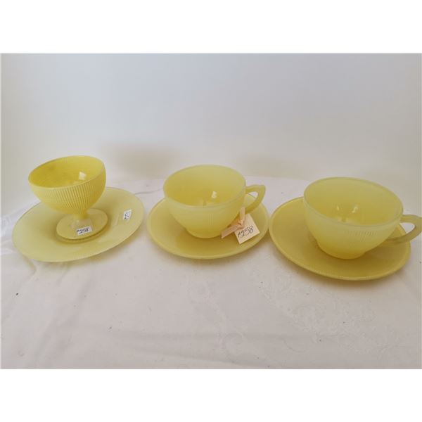 Yellow Saguenay cups and saucers (2), and one yellow sherbet with saucer