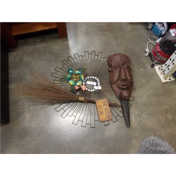 Sunburst wall hanging and carved mask with duster and wind chime