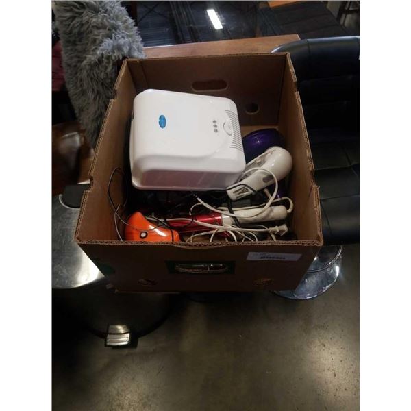 Box of UV nail dryers, hair dryer, curling iron and more