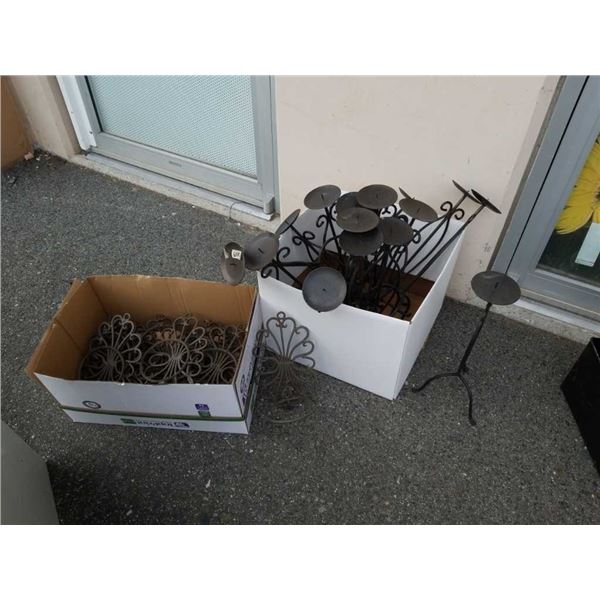 Two boxes of decorative metal candle stands and plant holders