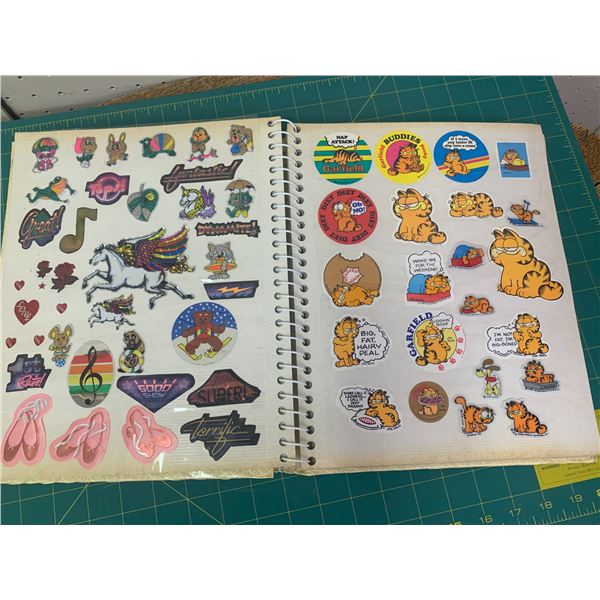 PHOTO ALBUM OF APPROX 200 VINTAGE STICKERS SMURFS GARFIELD SCRATCH AND SNIFF GREMLINS AND MORE