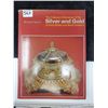 Image 1 : silver & gold coloured dictionary
