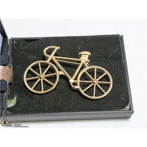 A GOLD TONE VINTAGE BICYCLE BROOCH