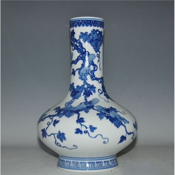 A BLUE AND WHITE GRAPES BOTTLE VASE KANGXI MARK.