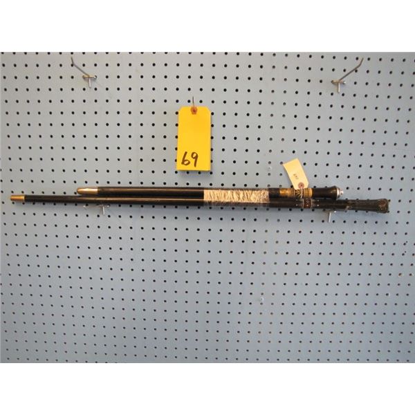 black decorated walking stick and black sword stick with lions head decoration