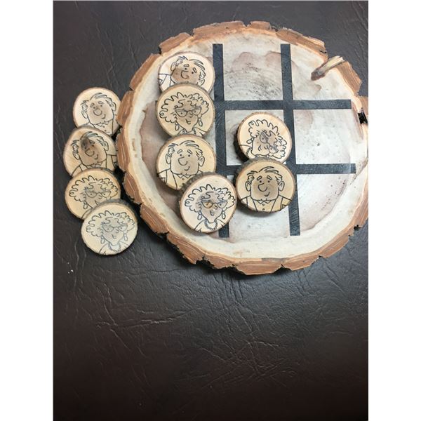Wood slice with laser engraved tic-tac-toe game pattern and pieces