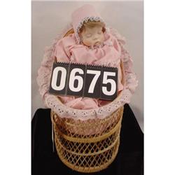 Porcelain And Bean Bag Doll In Wicker Crib
