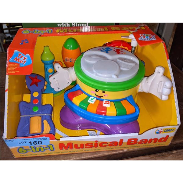 Lot of two toys including six in one musical band and old fashioned gumball machine and Bank with s