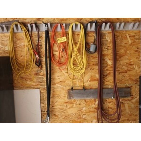 QUANTITY OF CORDS, HOSES, & BOOSTER CABLES ON WALL