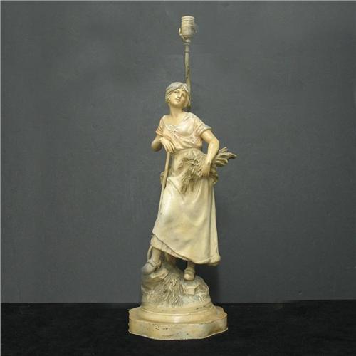 Painted spelter figural lamp; woman holdin