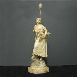 Painted spelter figural lamp; woman holdin